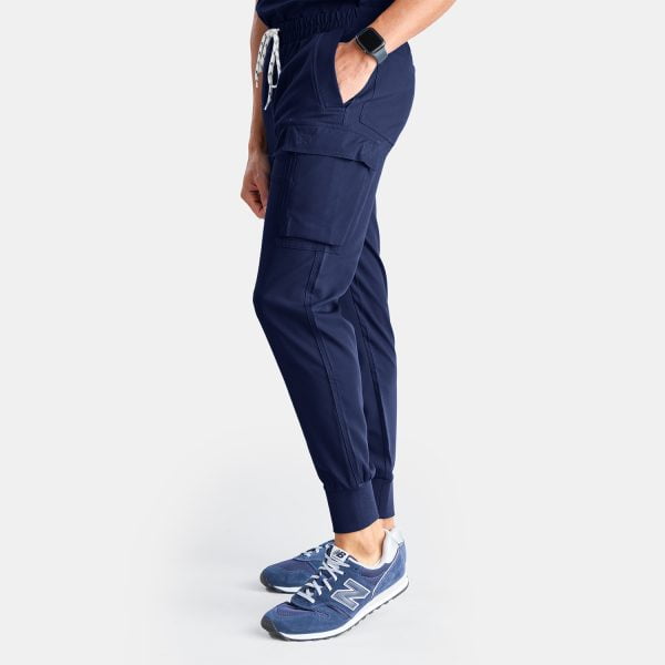 Side View of Man Wearing Unisex Cargo Jogger Scrub Pant in Twilight/navy by Designs to You