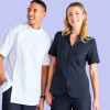 Pharmacy Uniforms Australia: a Smiling Young Woman and Man Posing Together. the Man is Wearing a Classic Pharmacy Jacket, and the Woman is Wearing a French Navy Zip Front Tunic.