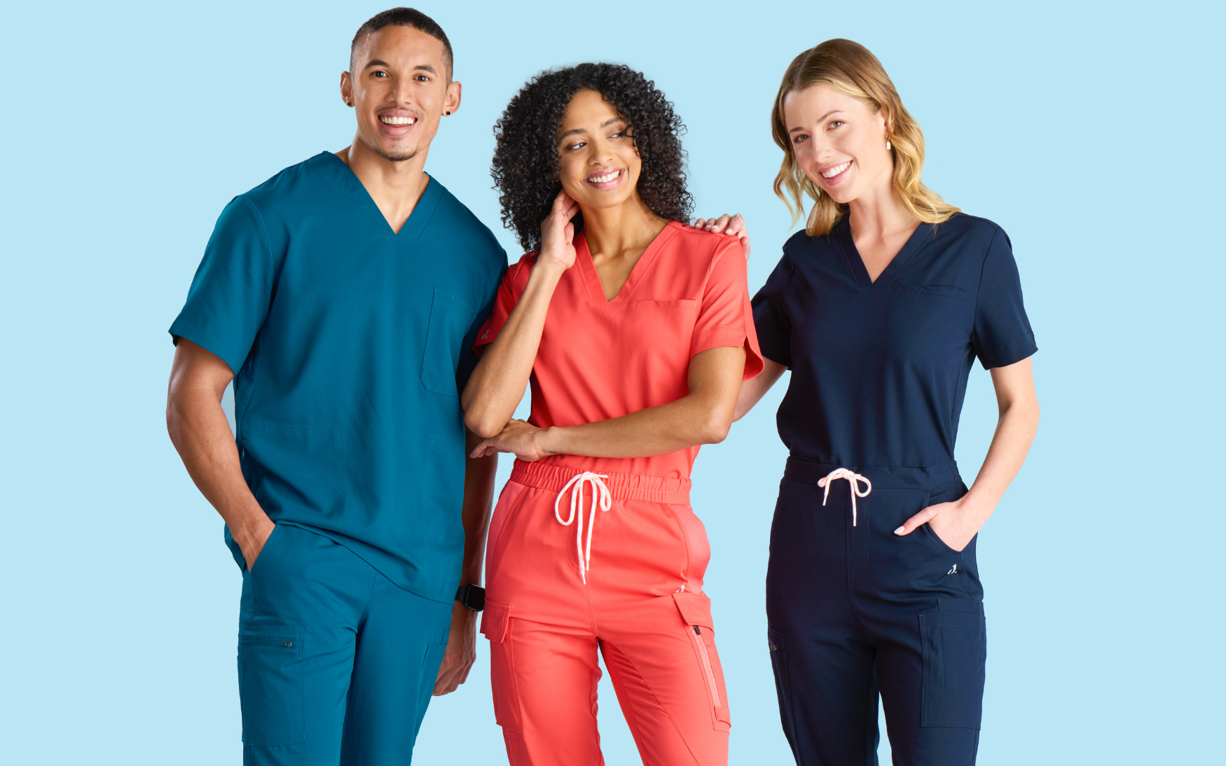 Three veterinary professionals posing together wearing vet nurse scrubs by Designs To You.