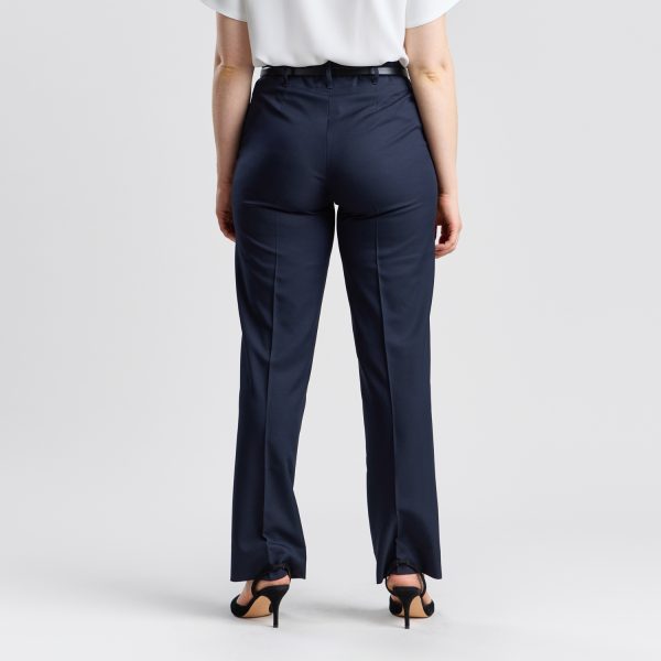 Rear View of a Woman in Designs to You's Relaxed Leg Pant with Elastic Back in French Navy, Standing Against a Neutral Background.