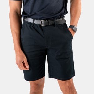 808 French Navy Men's Chino Short - Designs To You - 1 | Designs To You the Lower Half of a Man Dressed in Professional Attire, Featuring Dark Navy Chino Shorts Paired with a Black Belt by Designs to You. the Shorts Have a Relaxed Fit and Are Knee-length.