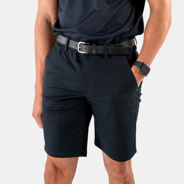 a Side View of a Man Wearing a Dark Navy Polo Shirt, Matching Chino Shorts and a Sleek Black Belt by Designs to You.