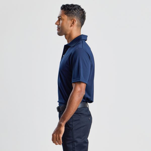 a Side View of a Man Wearing a Men's Eco Bamboo Polo in Navy, Showing the Fit Along the Torso and Sleeve.