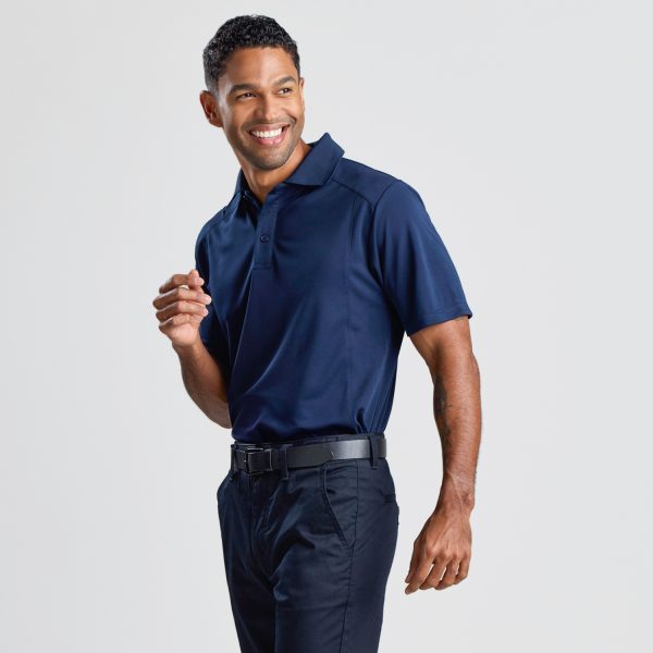a Man Smiling and Posed at a 45-degree Angle, Wearing a Men's Eco Bamboo Polo in Navy.