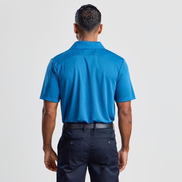 the Back View of a Man Donning a Men's Eco Bamboo Polo in Aegean Blue, Illustrating the Shirt’s Back Detailing and Collar Design.