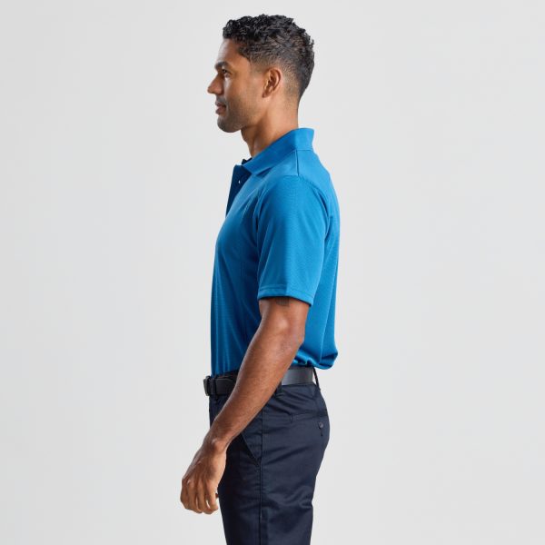 a Side View of a Man Wearing a Men's Eco Bamboo Polo in Aegean Blue, Showing the Garment's Profile and Fit.