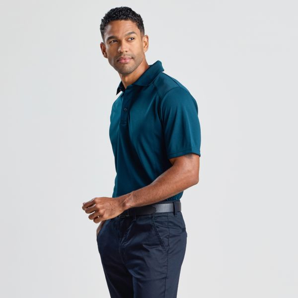 a Three-quarter View of a Man Wearing a Men's Eco Bamboo Polo in Ocean Blue, Semi-turned to the Camera.