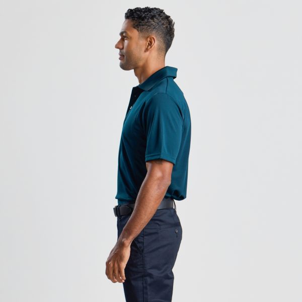 a Side View of a Man Wearing a Men's Eco Bamboo Polo in Ocean Blue, Highlighting the Fit and Sleeve Detail.