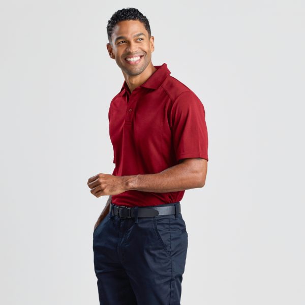 a Man Posed at a 45-degree Angle Wearing a Men's Eco Bamboo Polo in Ruby, Showing the Shirt's Overall Fit and Style.