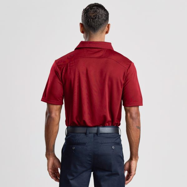 the Back View of a Man Wearing a Men's Eco Bamboo Polo in Ruby, Showcasing the Shirt's Fit and Fold of the Collar.