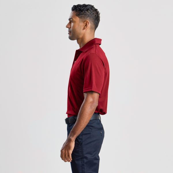 a Profile View of a Man Wearing a Men's Eco Bamboo Polo in Ruby, Highlighting the Shirt's Side Fit and Collar.