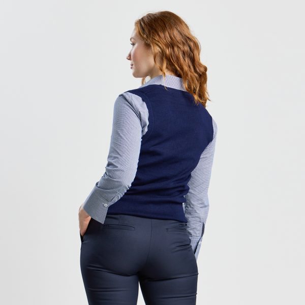 Rear View of a Woman in a Navy V-neck Pullover Vest over a Grey Button-up Shirt, Showcasing the Back Fit.