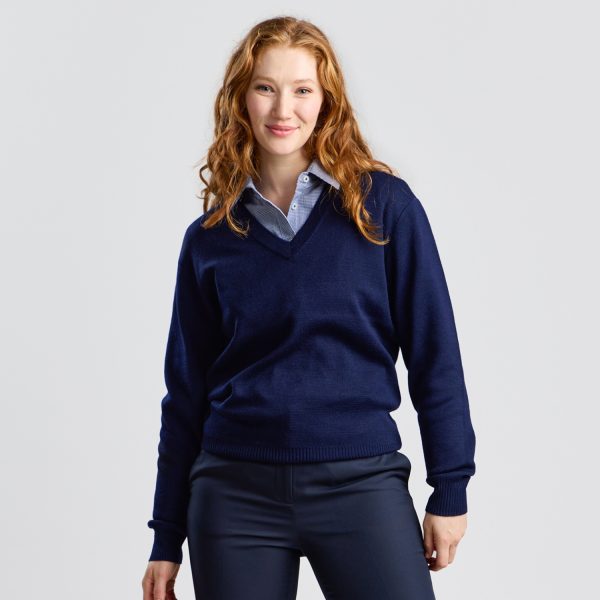 Front View of a Woman Smiling, Wearing a Navy V-neck Pullover over a Collared Shirt.