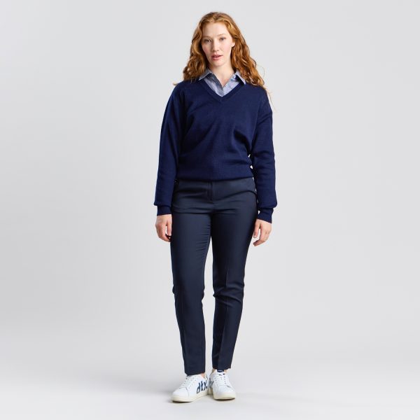 Full-length Image of a Woman in a Navy V-neck Pullover and Navy Trousers, Paired with White Sneakers, Looking Relaxed.
