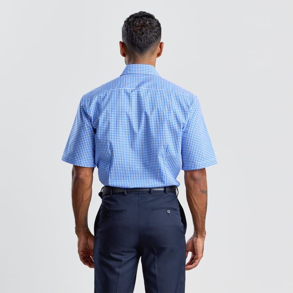 Back View of a Man Wearing a Blue Checkered Short Sleeve Shirt and Navy Trousers.