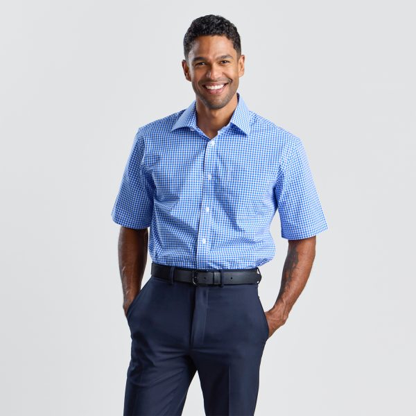 Front View of a Smiling Man Wearing a Blue Checkered Short Sleeve Shirt Tucked into Navy Trousers.