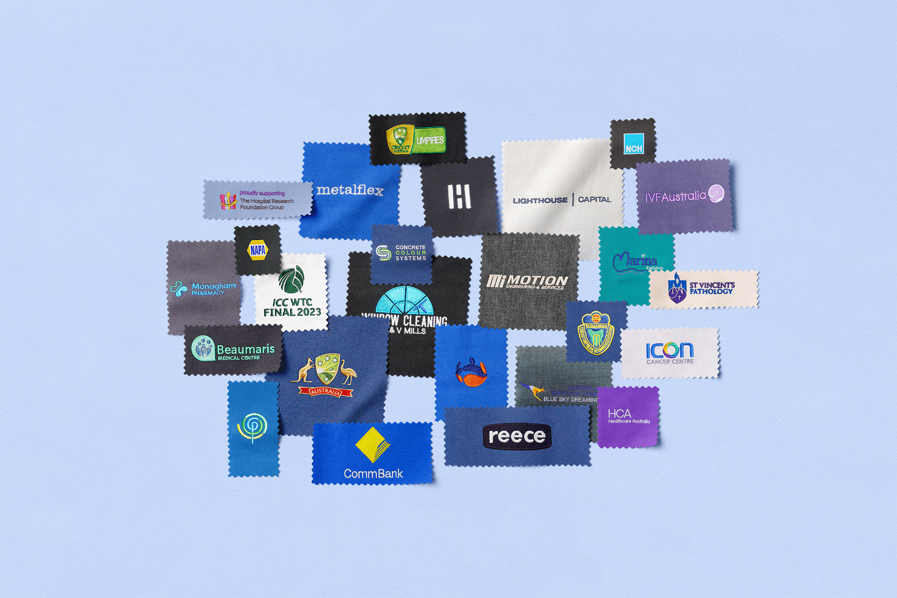 A collection of embroidered swatches displaying various company logos on a light blue background.