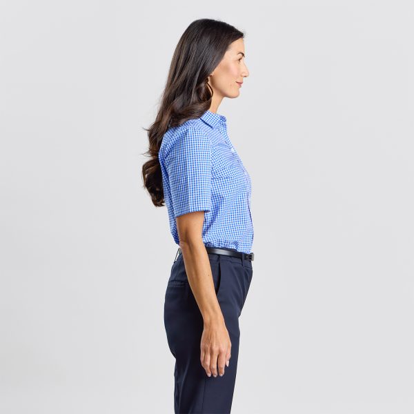 Side View of a Woman Wearing a Blue Checkered Short Sleeve Shirt Tucked into Navy Trousers