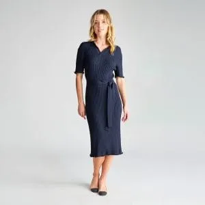 Woman Wearing a Navy Milano Knit Dress with a Tie Belt, Standing with Hands at Her Sides.