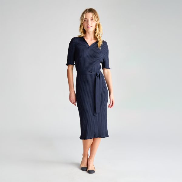 Woman Wearing a Navy Milano Knit Dress with a Tie Belt, Standing with Hands at Her Sides.