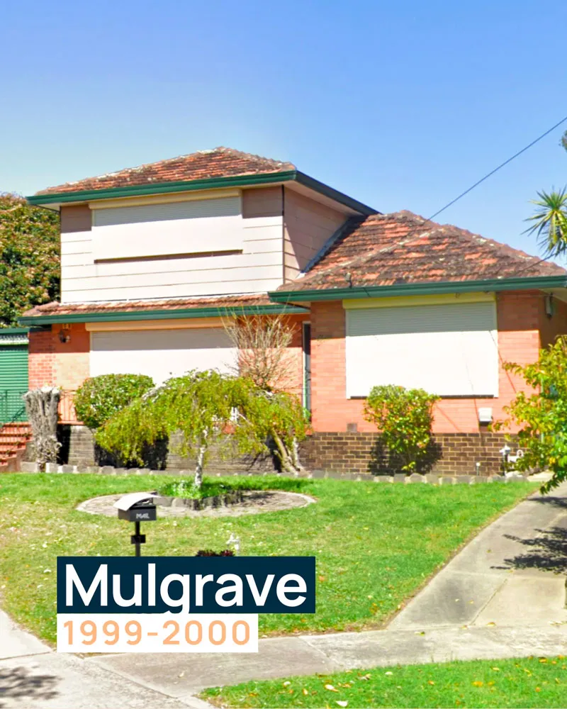 a Brick House with a Sloped Roof and Roller Shutters on the Windows, Surrounded by a Tidy Green Lawn. This Was the Very First Office for Designs to You Before Transitioning to Larger Commercial Spaces.