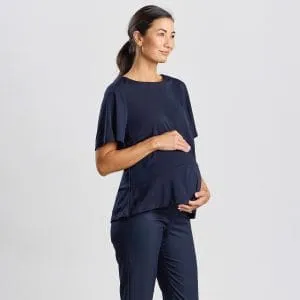 Side Profile of a Woman in a Navy Short Sleeve Peplum Maternity Top, Gently Cradling Her Baby Bump.