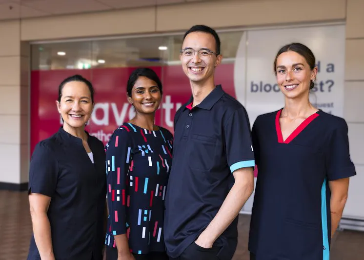 Healius Team Standing Together in Uniform, Posing Confidently in Front of the Clinic.